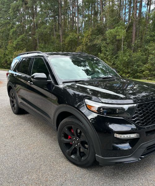 A black suv parked in a parking lot